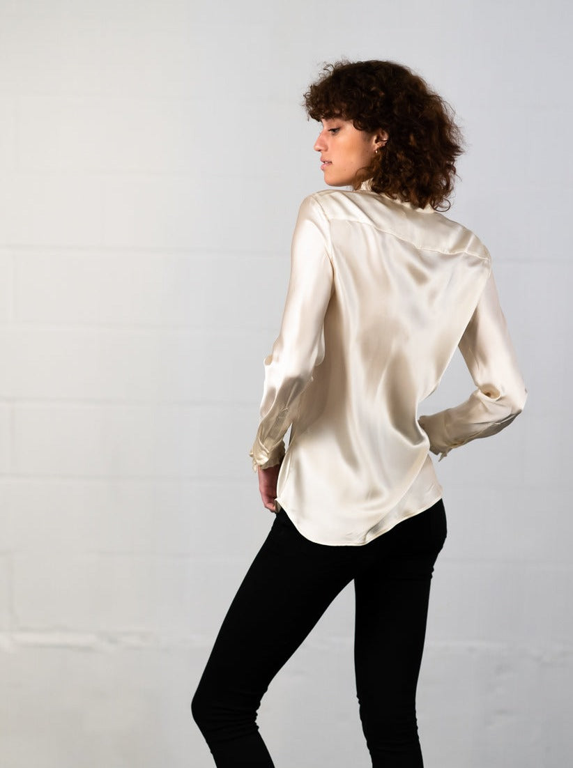 Marabilis blouse in ivory silk satin worn by model showing her back.
